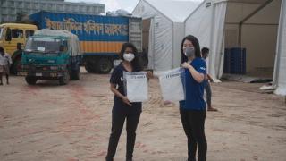 Srabasti Sarker from the Logistics Sector and Sua Choi from WFP holding JTS gowns upon their arrival at the Cox’s Bazar COVID-19 Special Hub. Photo: WFP/Brook Dubois